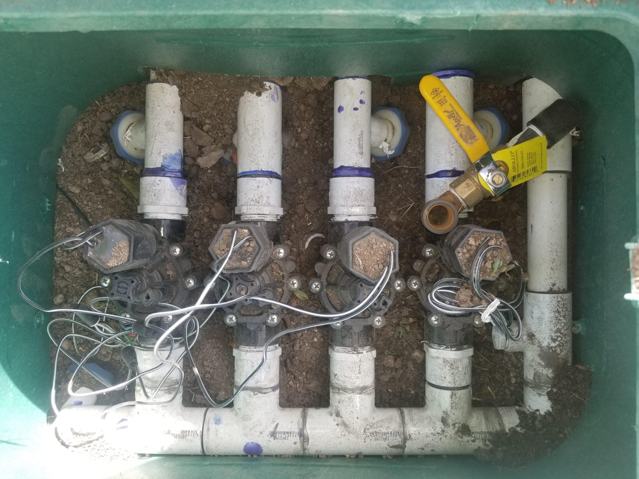 Irrigation valve manifold inside a green valve box